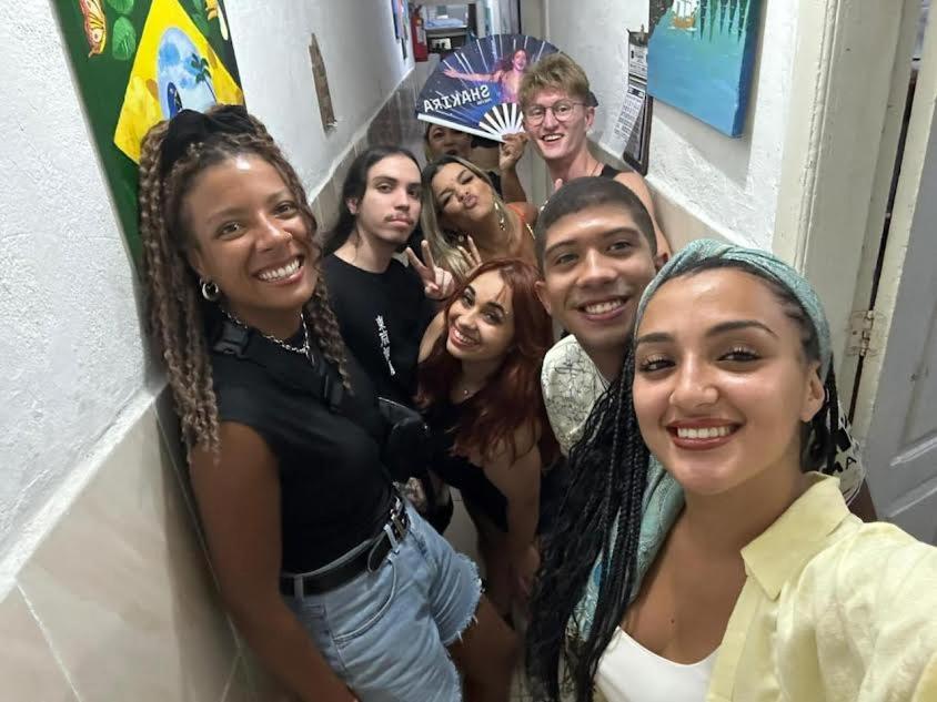 a group of people posing for a picture at Hostel Cidade Nova, próximo a estação metrô praça 11, onde você tem acesso direto a quaisquer Shows nas praias da zona Sul in Rio de Janeiro