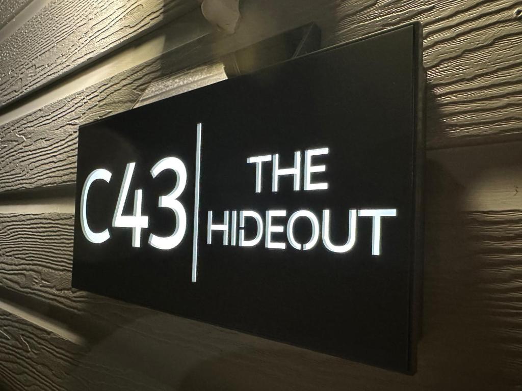 a sign that reads theoit hanging on a wall at C43 The Hideout in Rowen