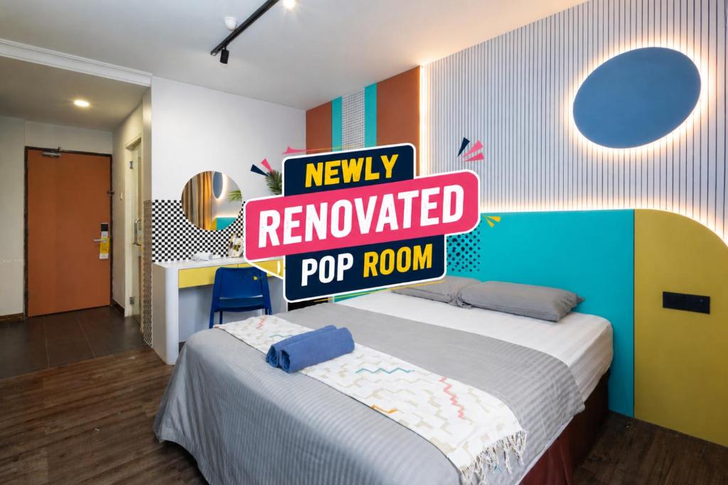 a room with a bed with a sign that reads newly renovated pop room at Parkland Hotel in Brinchang