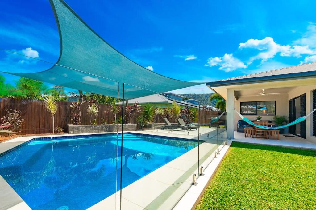 a swimming pool in the backyard of a house at Tropical Dreams - Spacious Retreat with Private Pool in Smithfield