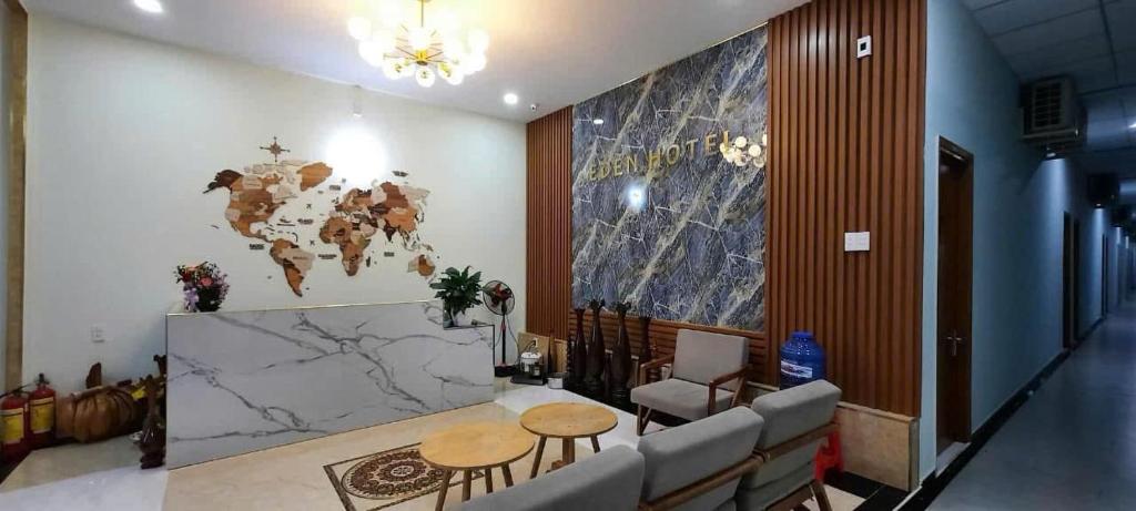 a lobby with a world map on the wall at Khách sạn EDEN Chơn Thành in Chơn Thành