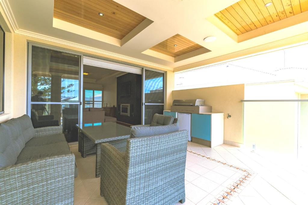 a living room with a couch and a table at Marina Views Mindarie in Mindarie