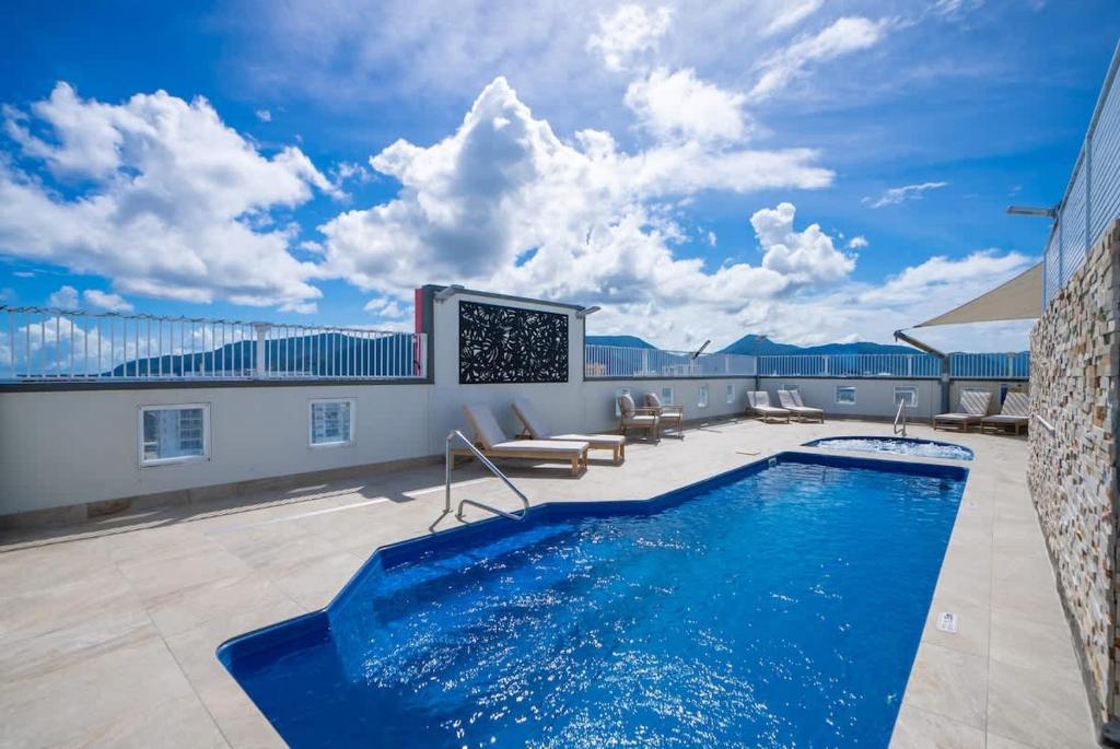 a swimming pool on the roof of a building at 'The Sand Dollar' Central Cairns Chic with Adjacent Studio in Cairns