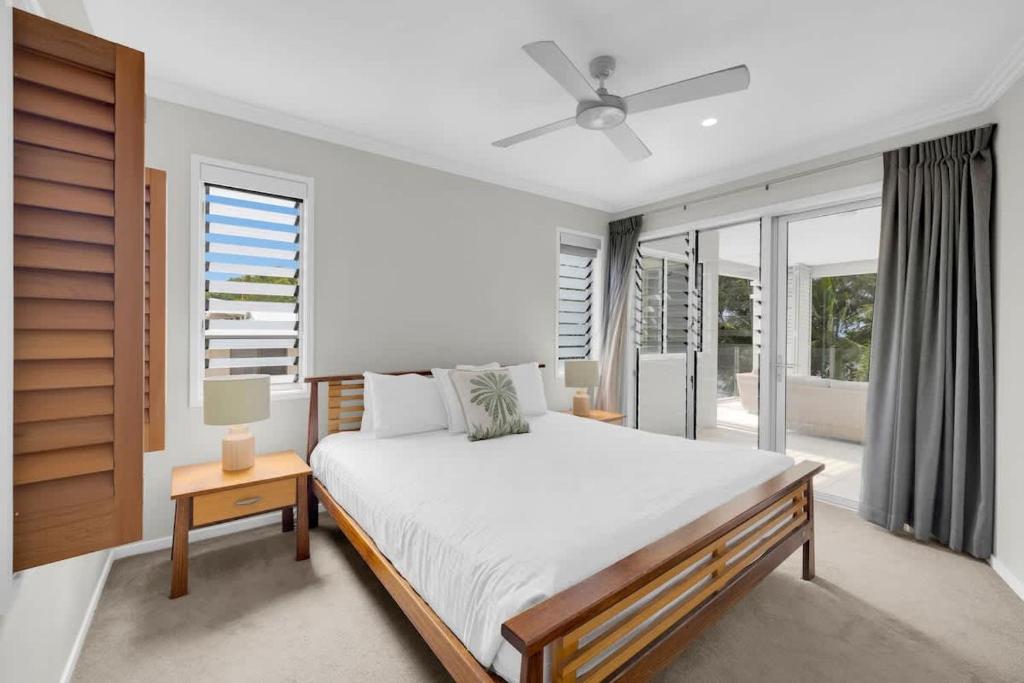 a bedroom with a bed and a large window at Turquesa Tides - Beachfront Resort Living in Palm Cove