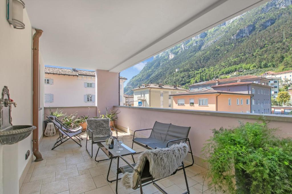 a balcony with chairs and a table with a view at Suite 22 - Happy Rentals in Riva del Garda