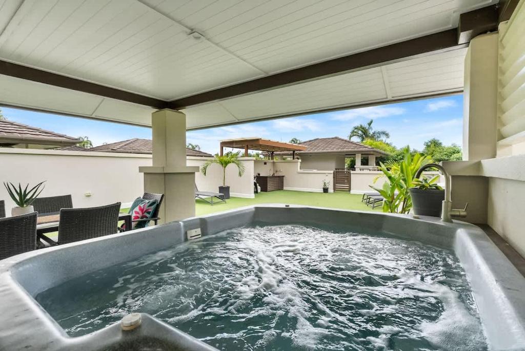 a hot tub in the backyard of a house at Rooftop Tranquility at Stunning Temple Resort in Port Douglas