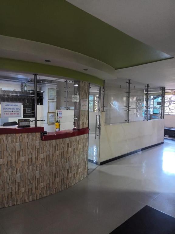 a lobby with a counter in a building at Hotel Rio Sol in Cali