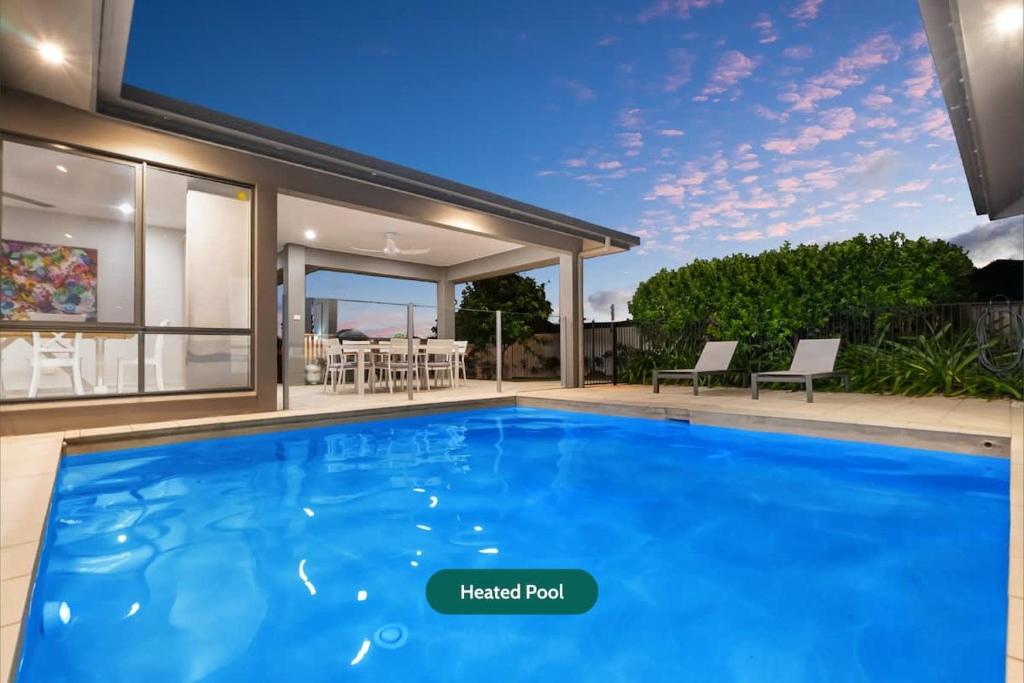 a swimming pool in the backyard of a house at Trinity Beach Oasis - Poolside Retreat and Serenity in Trinity Beach