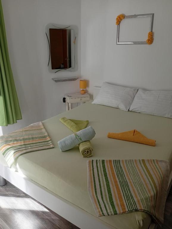 a large white bed with two pillows on it at The Palace Mattiazzi Room in Šibenik