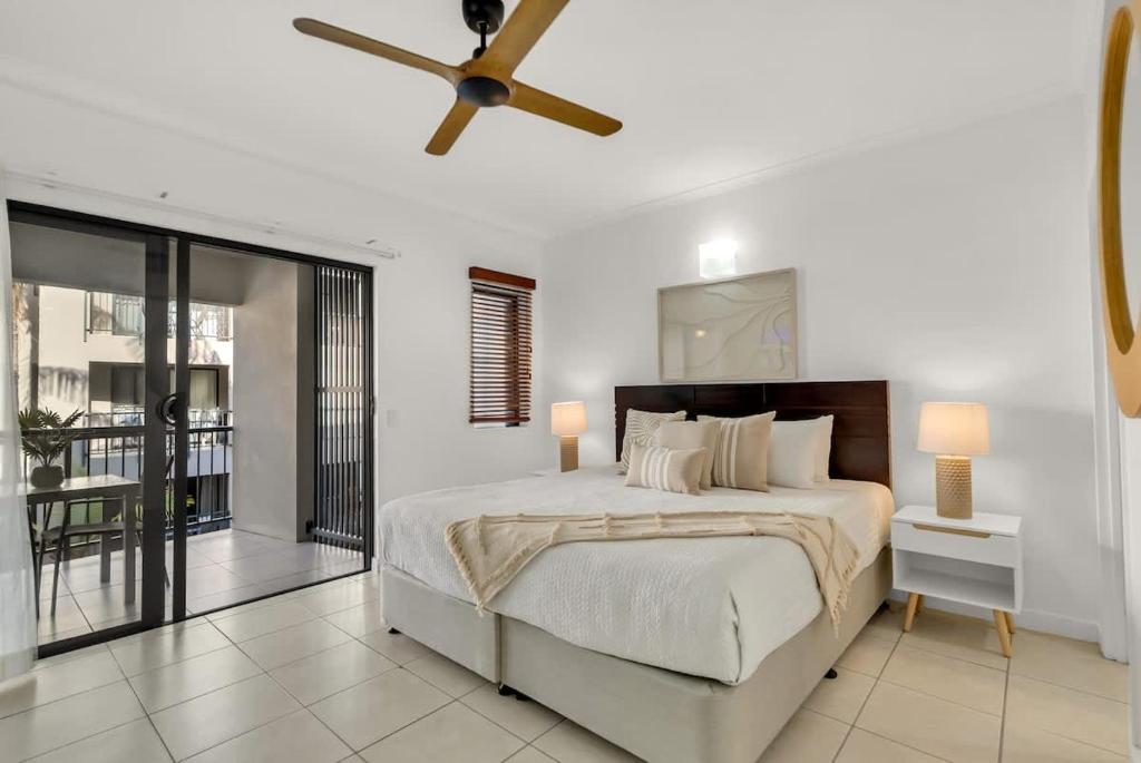 a bedroom with a bed and a ceiling fan at Lagoon Lookout - Poolside Studio near Trinity Beach in Trinity Beach
