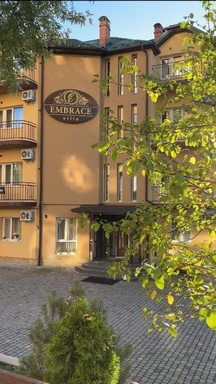 a large building with a sign on the side of it at Обійми Embrace in Truskavets