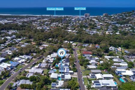 an aerial view of a city with houses and the ocean at Palm Haven Coolum Beach in Coolum Beach