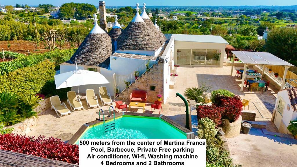an advertisement for a villa with a swimming pool at Trulli Fenice in Martina Franca