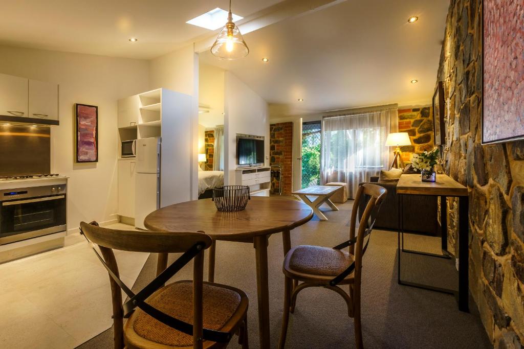 a kitchen and dining room with a wooden table and chairs at Bright Mystic Valley in Bright