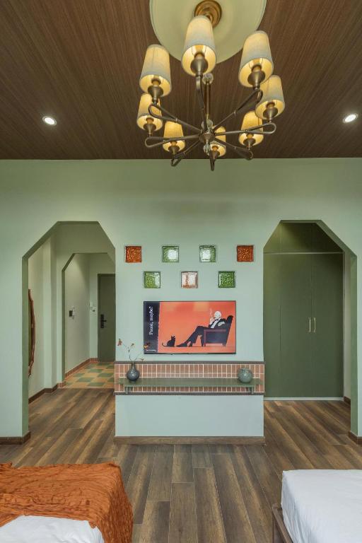 a large room with two beds and a television at 68 Hotel Go Cong in Gò Công