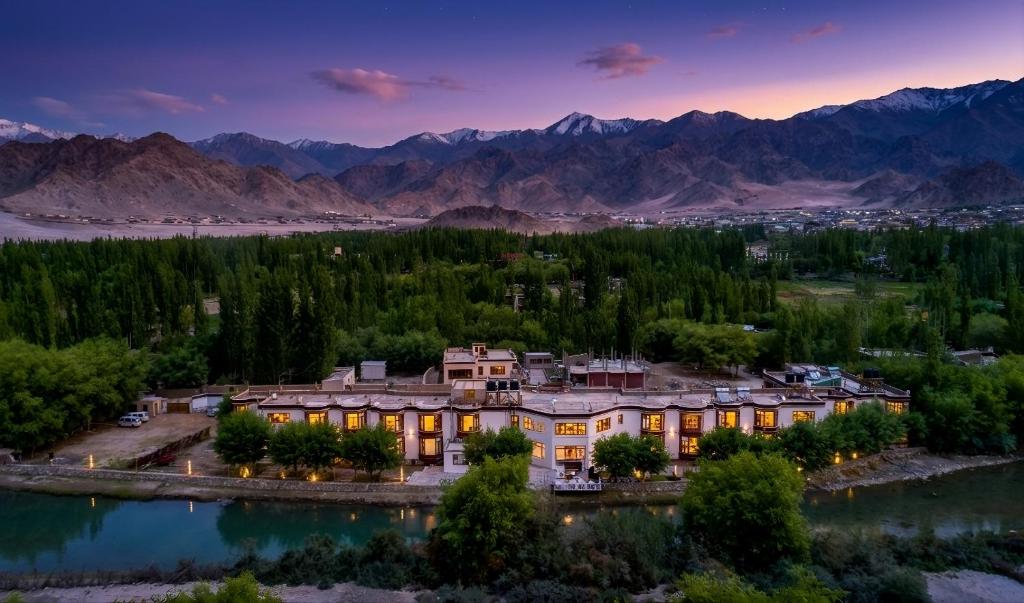 an aerial view of a resort with mountains at The Nature Residency - A Riverside Resort in Leh in Leh