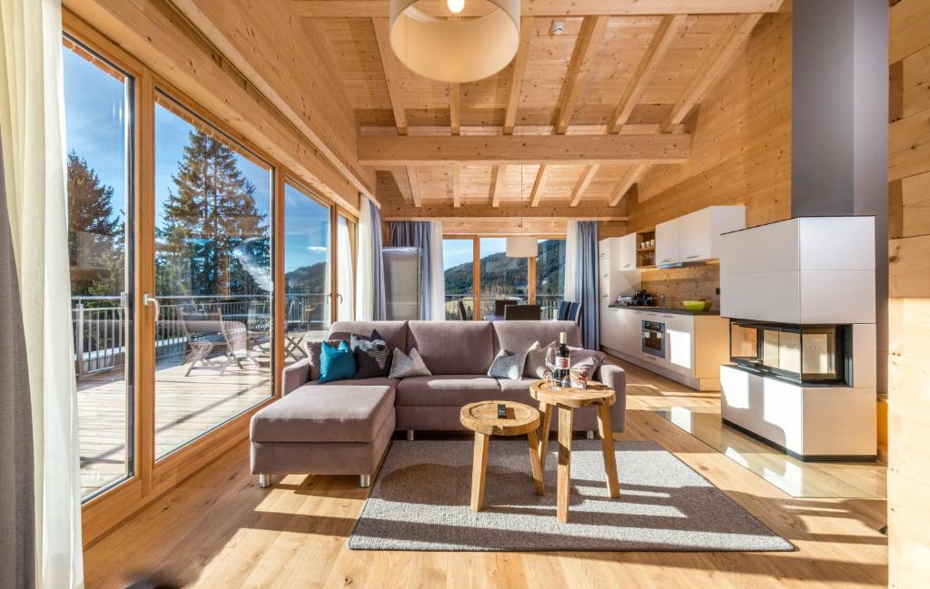 a living room with a couch and a table at Rittis Alpin Chalets Dachstein-inklusive Sommercard! in Ramsau am Dachstein