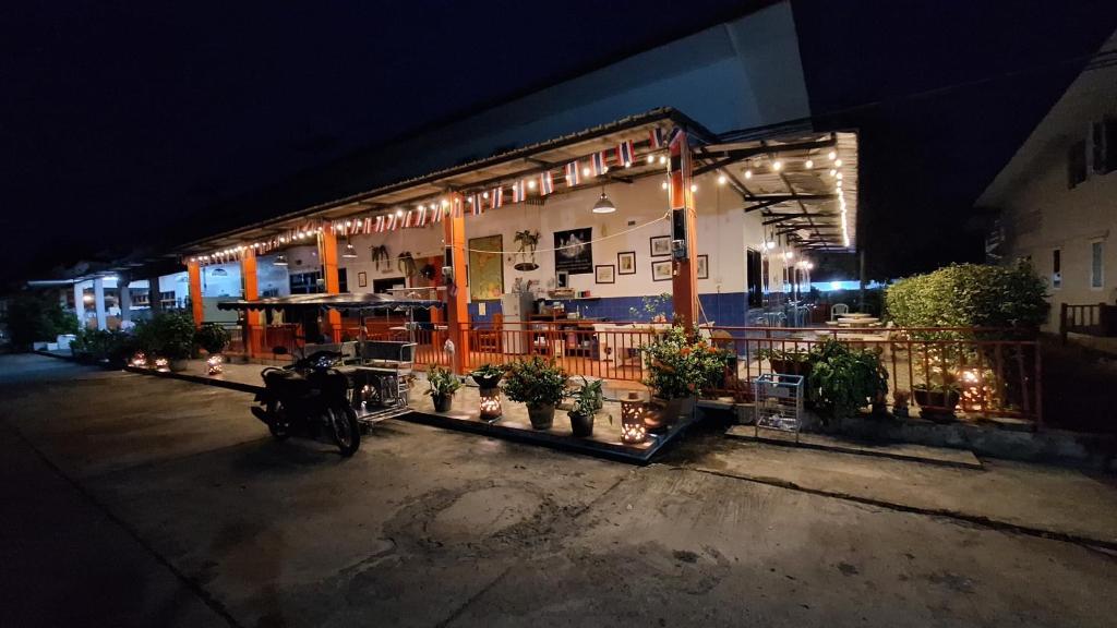 a motorcycle parked in front of a restaurant at night at Runa Runa The Best Samed Island in Ko Samed