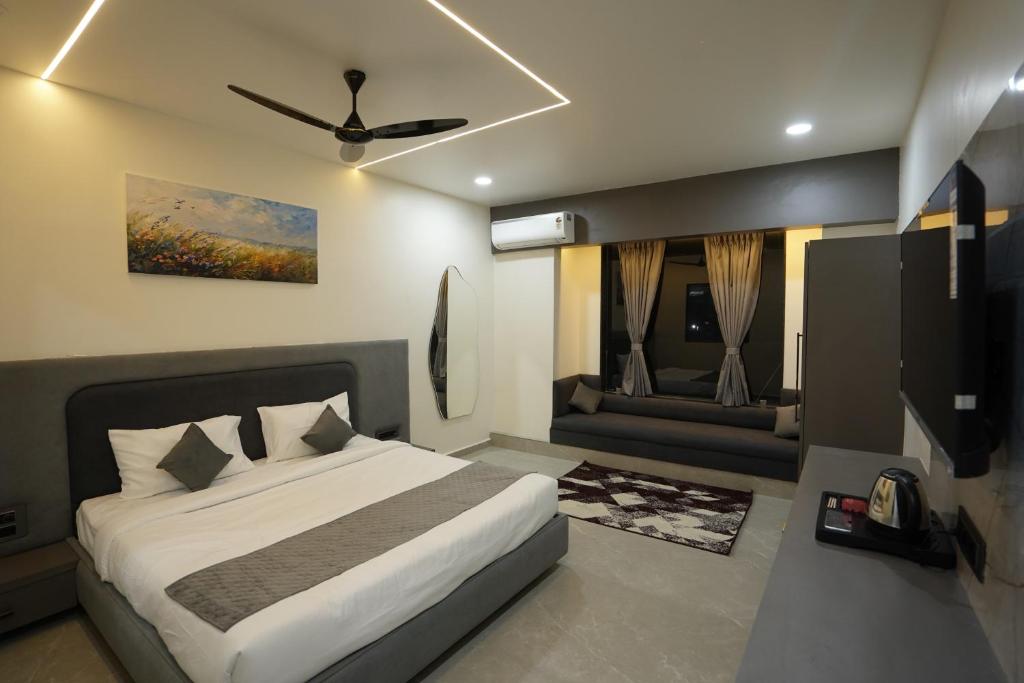 a bedroom with a bed and a flat screen tv at Hotel Ace Inn in Dr. Babasaheb Ambedkar International