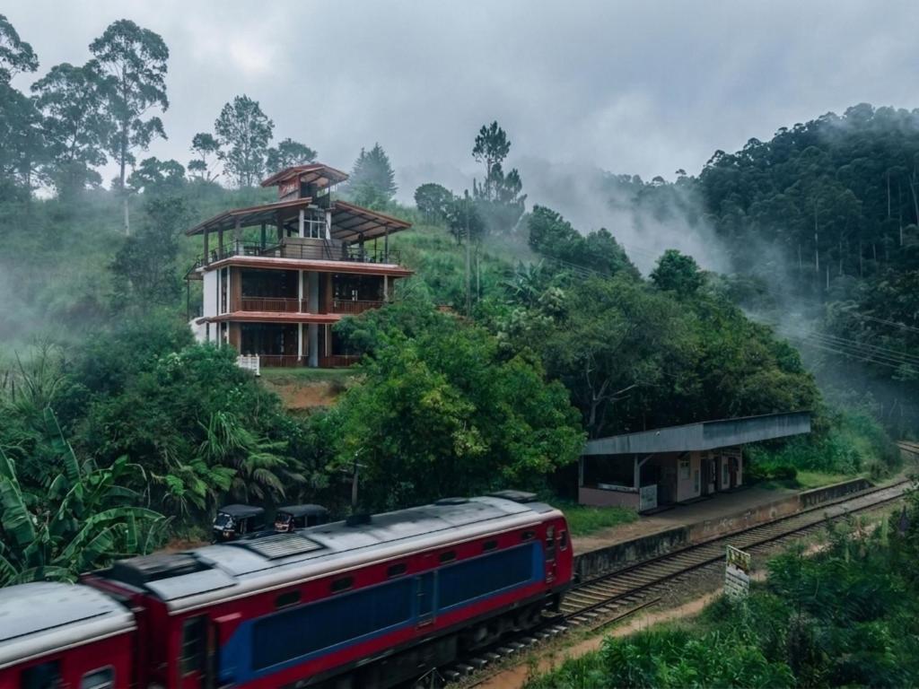 a train on the tracks in front of a building at Hotel Levon Ella in Ella