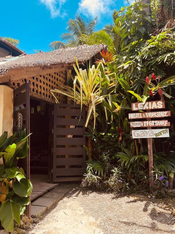 an entrance to a house with a sign in front at Lexias Hostel and Workspace - Siargao in Catagnan