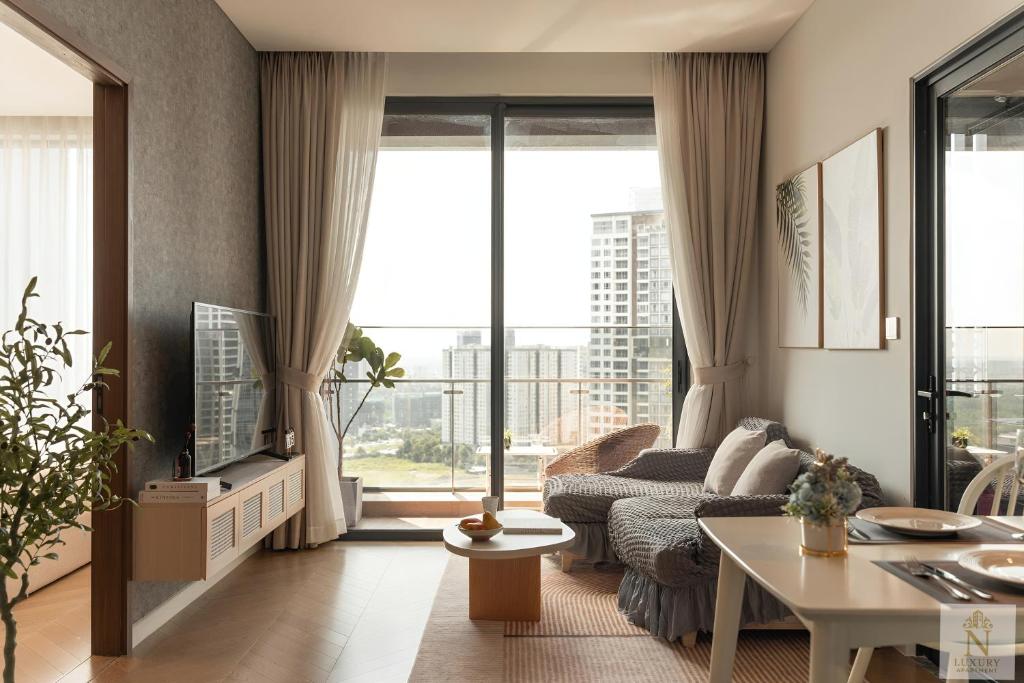 a living room with a couch and a table at Lumière Royal Sky Residence in Ho Chi Minh City