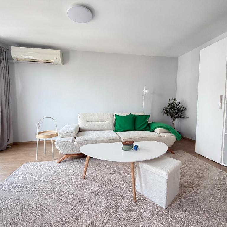 a living room with a couch and a table at Cool Downtown Apartment in Burgas