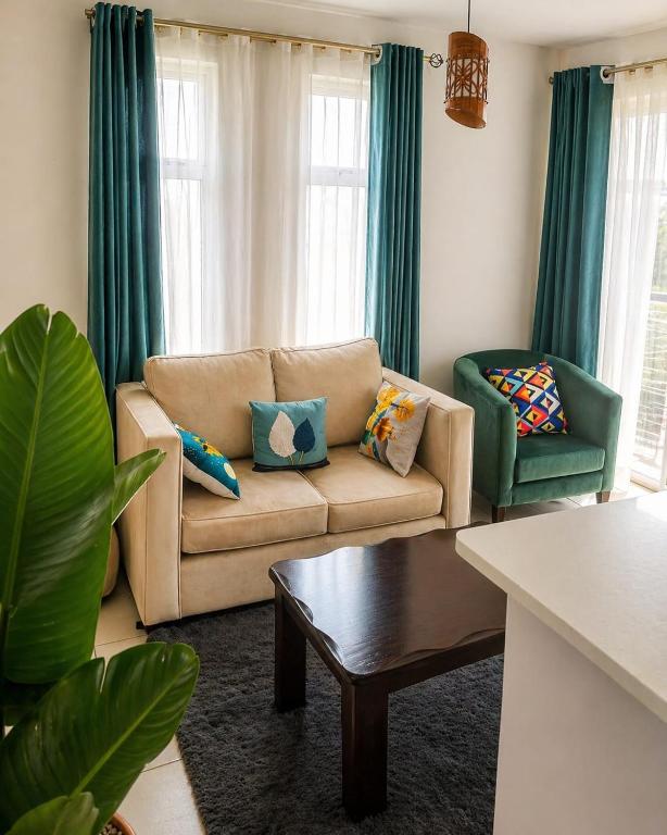 a living room with a couch and two chairs at kijani retreat in Nairobi