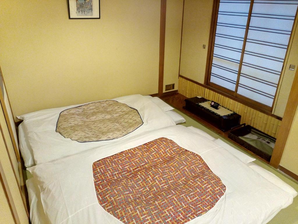 Postel nebo postele na pokoji v ubytování Hotel Edoya