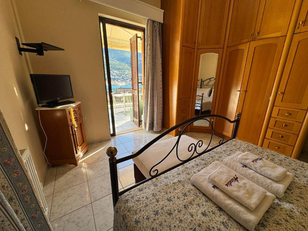 a bedroom with a bed with two towels on it at Christina's Apartments in Vathi