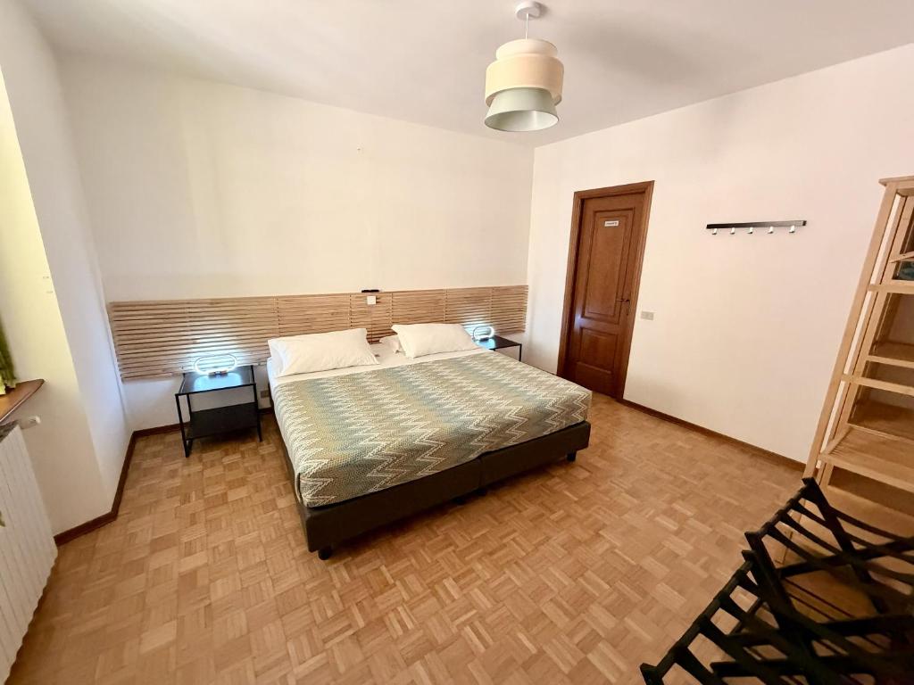 a bedroom with a bed and two chairs in it at Porta Del Ricetto in Candelo