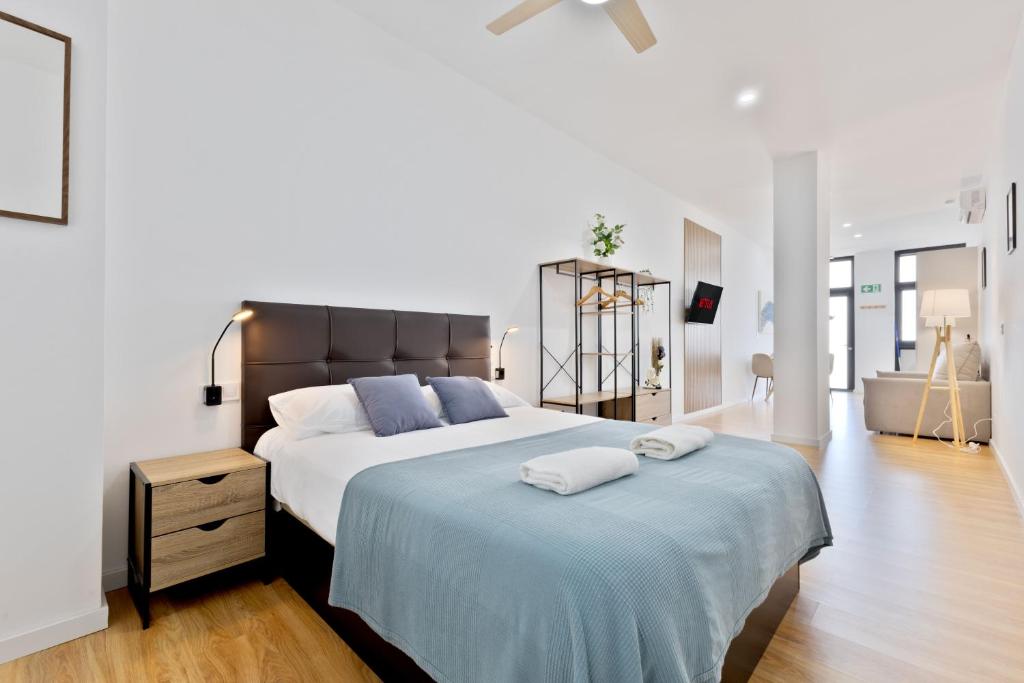 a bedroom with a large bed with two towels on it at Pato - Modern Apt - Near Bioparc by Río Turia Apartments in Valencia