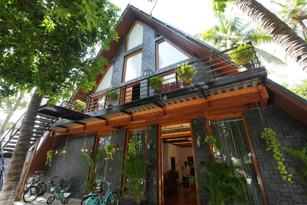 a house with a balcony on top of it at Moonlight Resorts Idappadi in Ammāpettai
