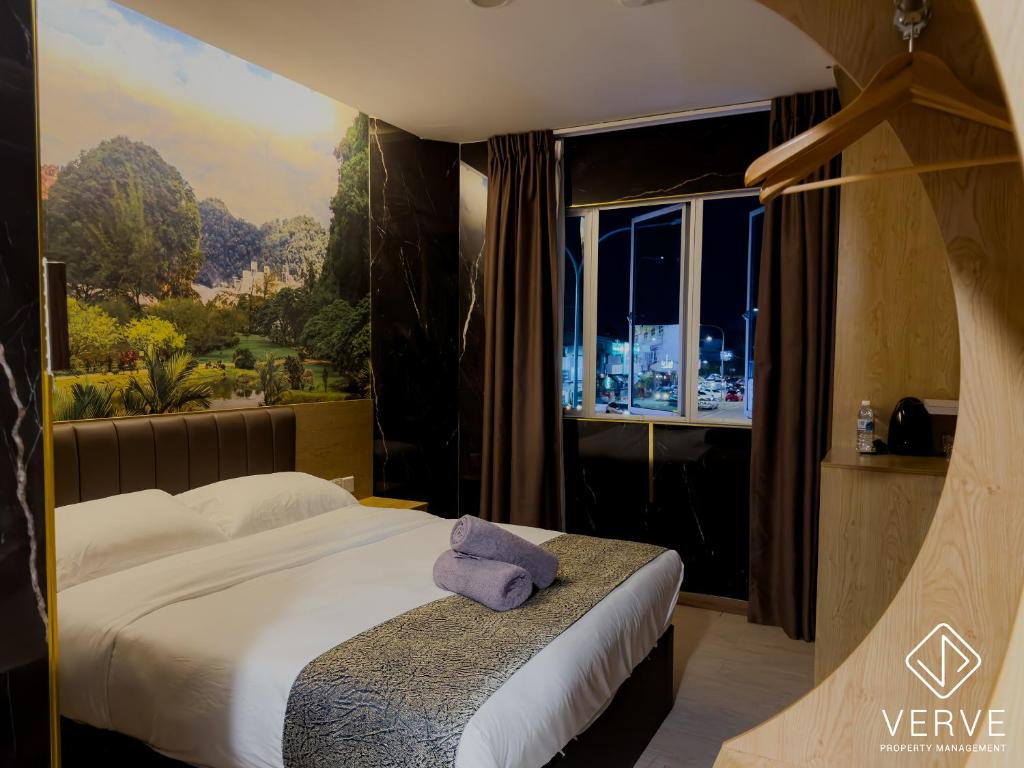 a bedroom with a bed and a large window at IPOH AVS HOTEL by VERVE in Ipoh