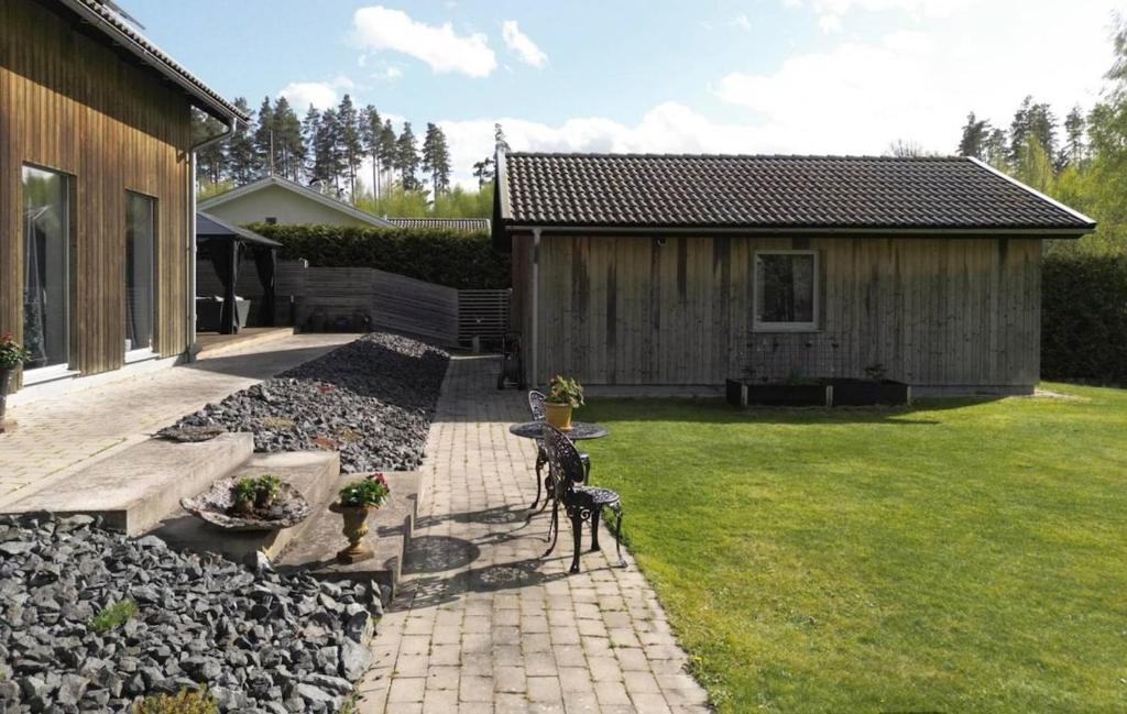 a garden with a house and a statue of a dog at Comfy Modern Guesthouse in Bankeryd