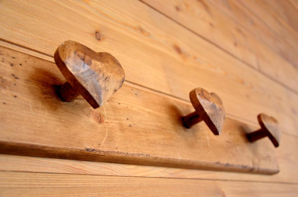 three pieces of wood on a wooden table with a knife at Résidence - Les Grandes Alpes in La Clusaz