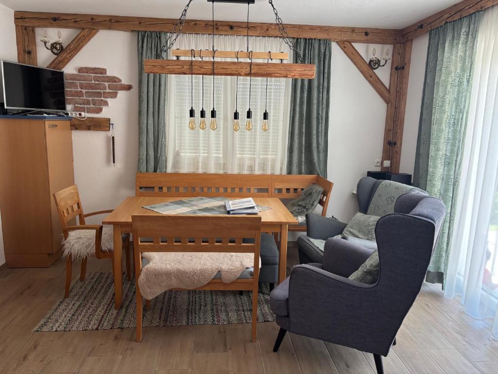 a living room with a dining room table and chairs at Ferienhaus Plöckenstein in Schwarzenberg am Bohmerwald