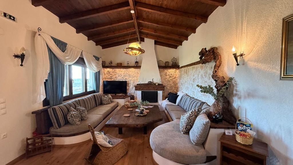 a living room with a couch and a table at Villa Di Mare in Mesimvría
