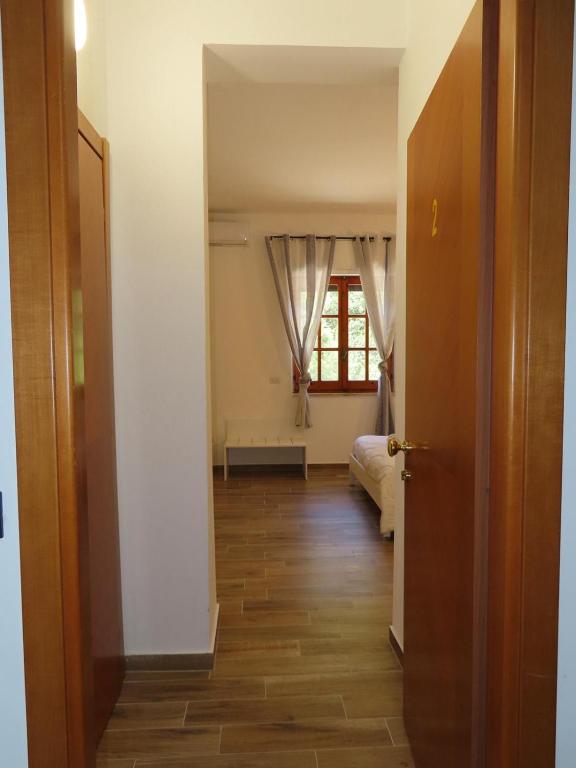a hallway with a room with a bed and a window at B&B Casa Lamanna in Torretta