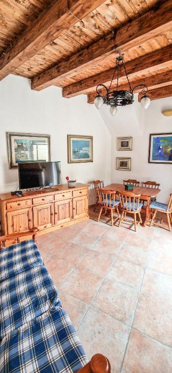 a large kitchen with a table and a dining room at Liana's home in Gallo