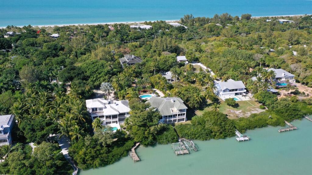 an aerial view of a house on an island in the water at Coconut Palm House in Captiva