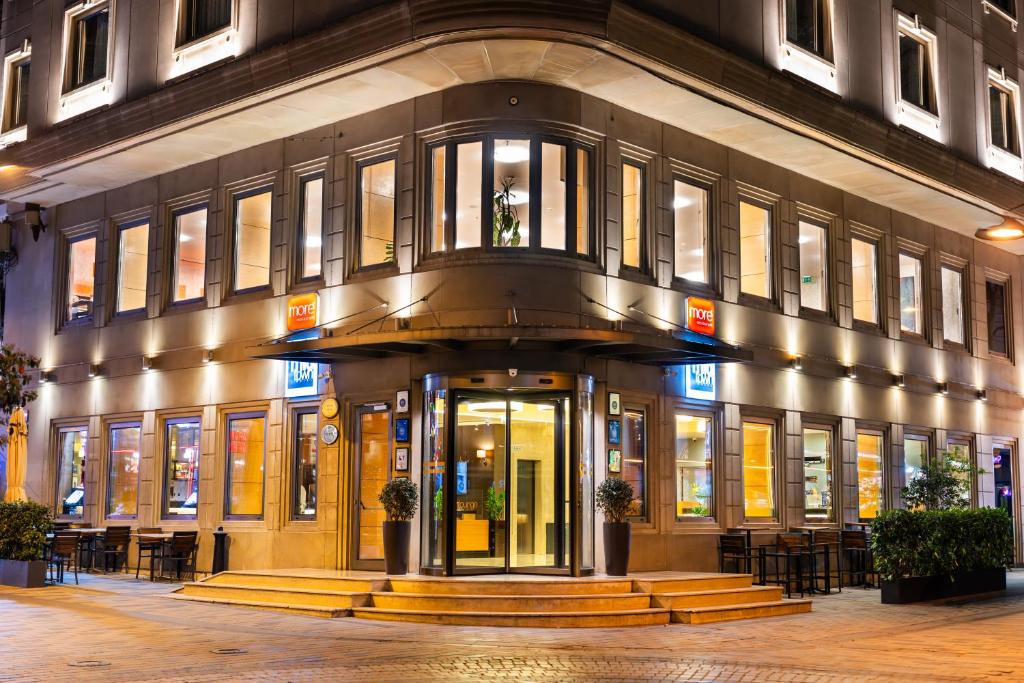 a large building with tables and chairs in front of it at Midtown Hotel in Istanbul