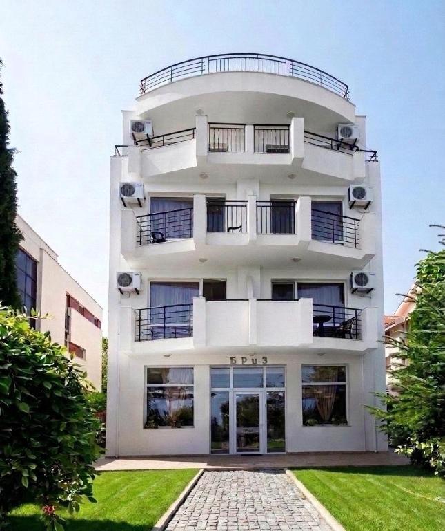 a white building with balconies on top of it at HOTEL BRIZ - Free Parking in Burgas