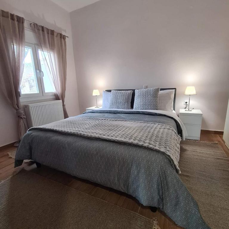 a bedroom with a bed with two lamps and a window at Rizes in Pramanta