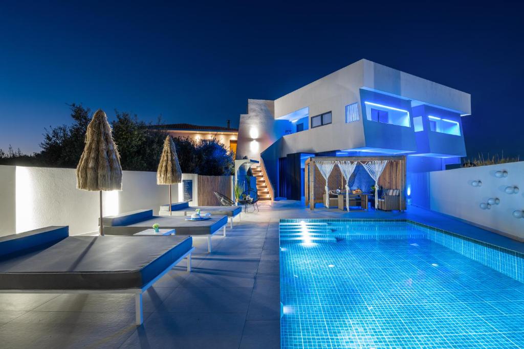 a villa with a swimming pool at night at Moon Boutique Hotel - Ultra Luxury Suites with Pool, Perfect for Fun and Relaxation By Villa Mana Gers in Laganas