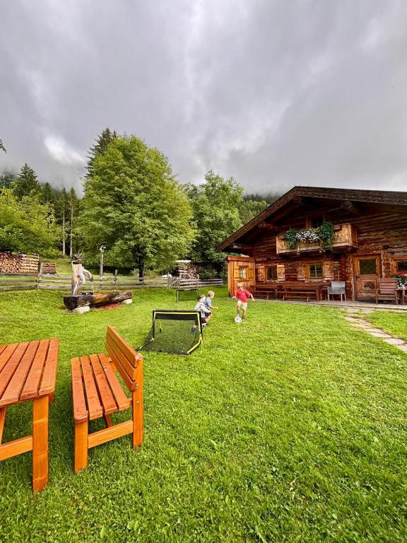 a park with a picnic bench and a swing at Schröckhütte in Bad Hofgastein