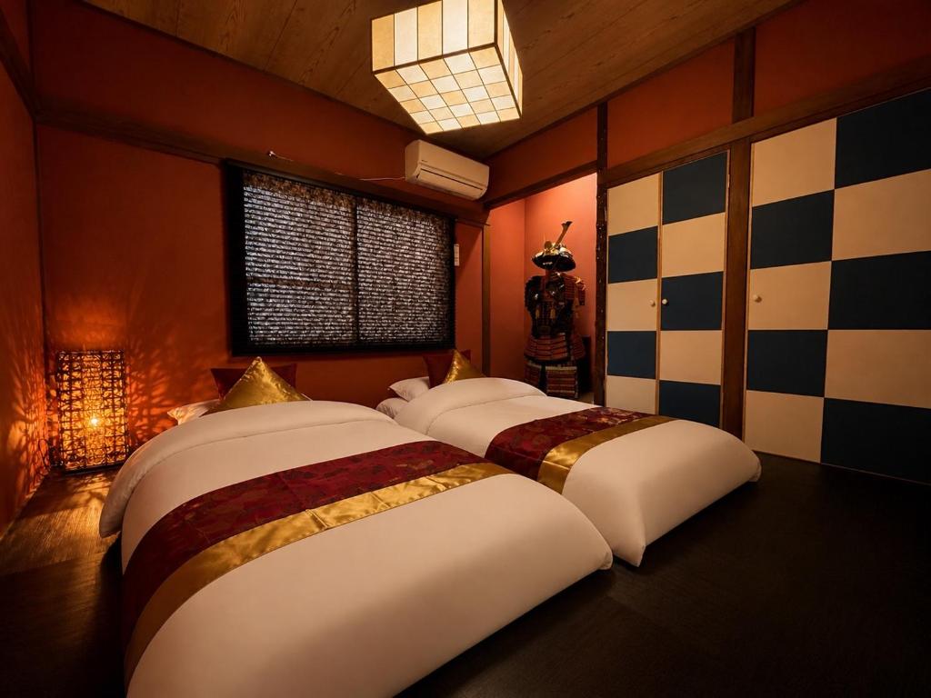 a bedroom with two beds in a room at 将軍町家 in Nagoya