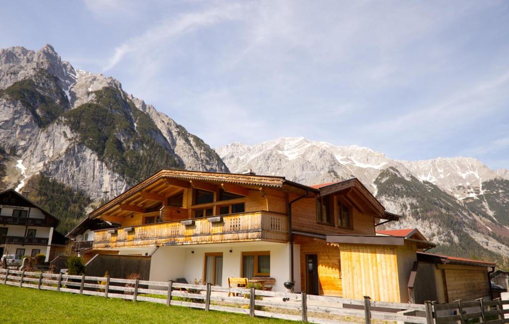 a building with mountains in the background at Alpenchalet im Leutaschtal in Leutasch