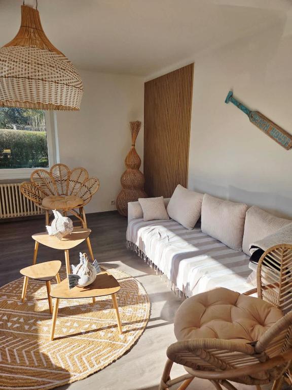 a living room with a couch and tables and chairs at Casa Lumina in Lachapelle-sous-Rougemont