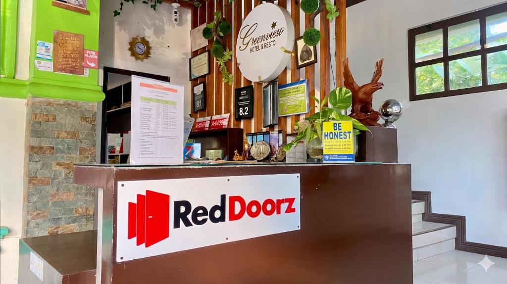 a red door sign on a counter in a store at RedDoorz @ Greenview Hotel and Restobar Masbate in Masbate